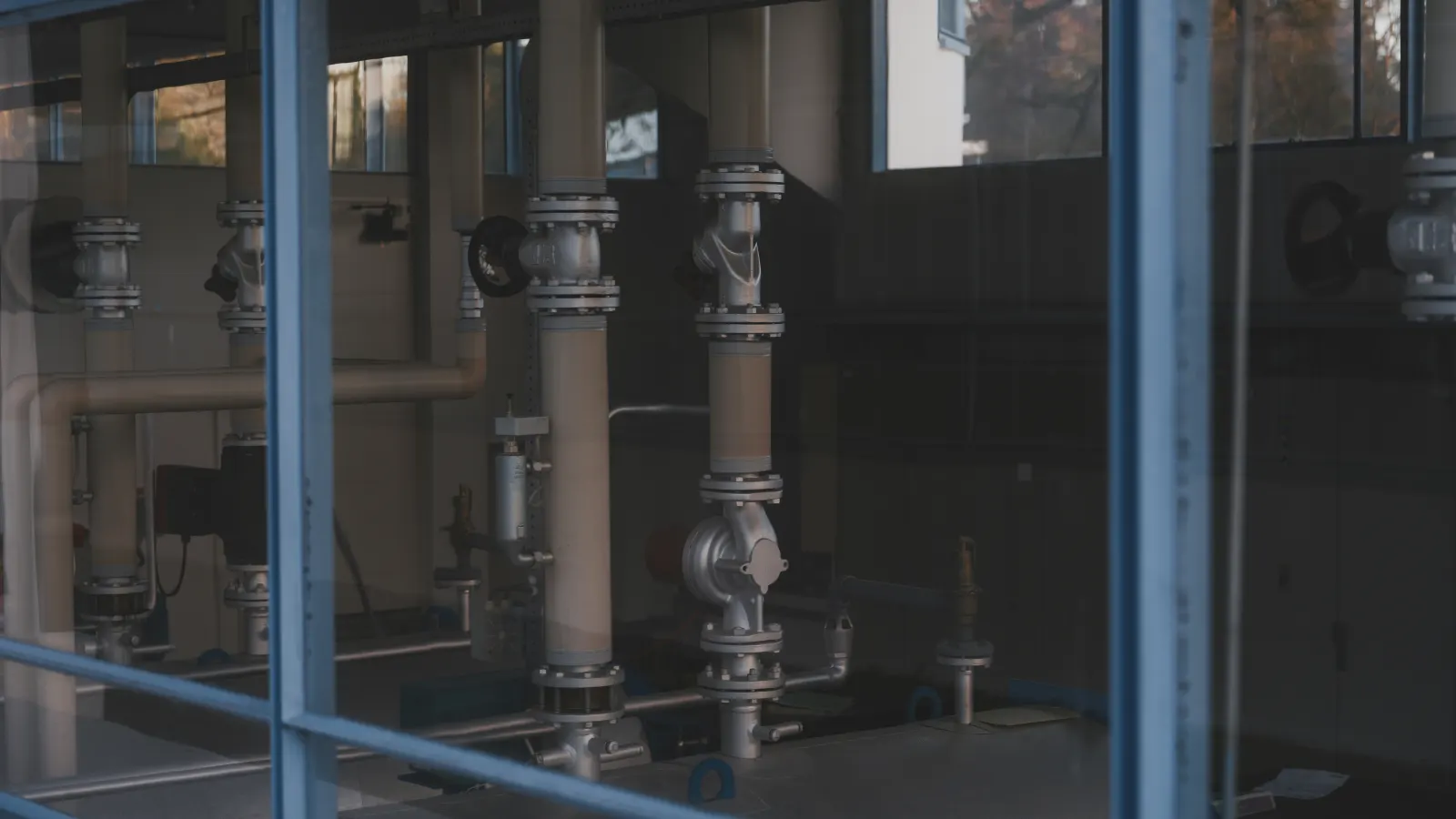 Industrial pipes, valves, and metal fittings inside a manufacturing facility