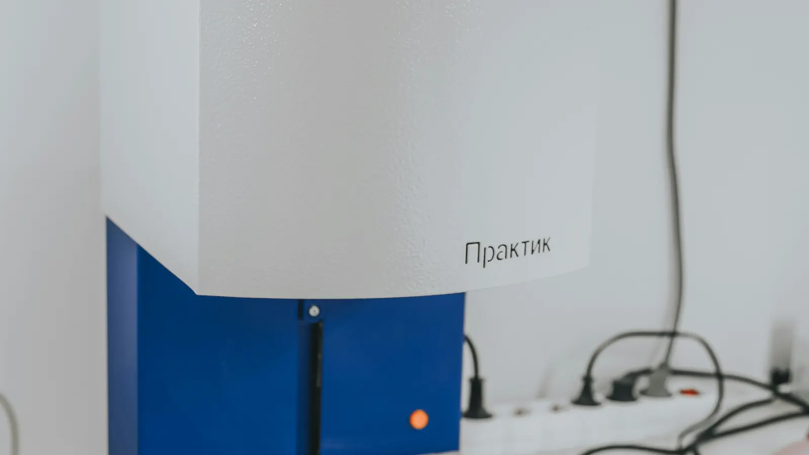 White and blue scientific instrument on a clean white surface