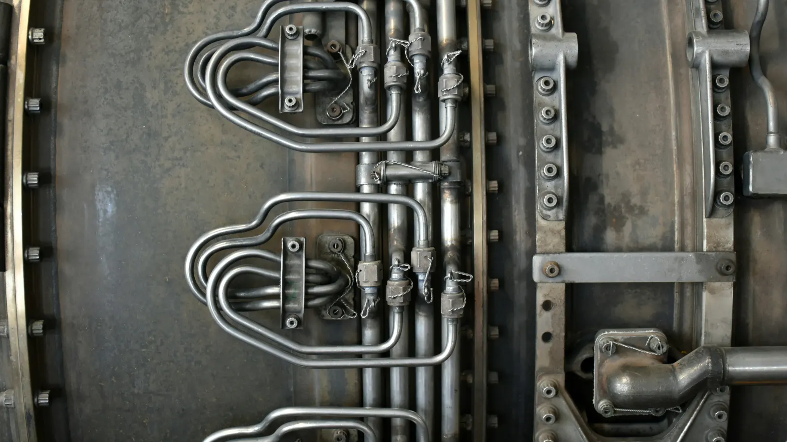 Close-up of polished metal industrial pipes and machined components