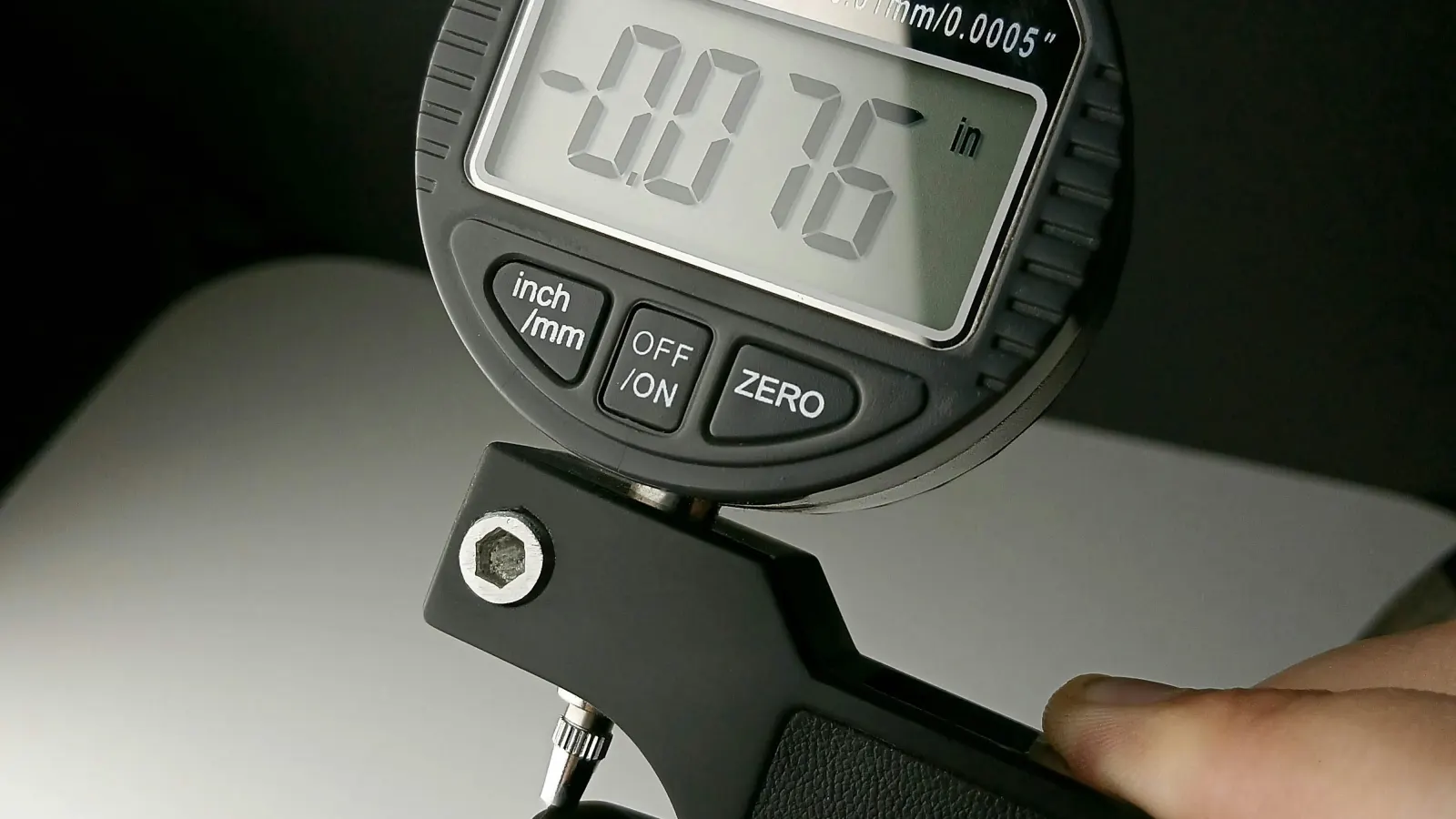 Close-up of a precision metal measurement instrument with a digital readout